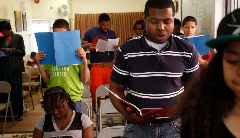 Jomo K. Johnson leading worship at a church plant gathering
